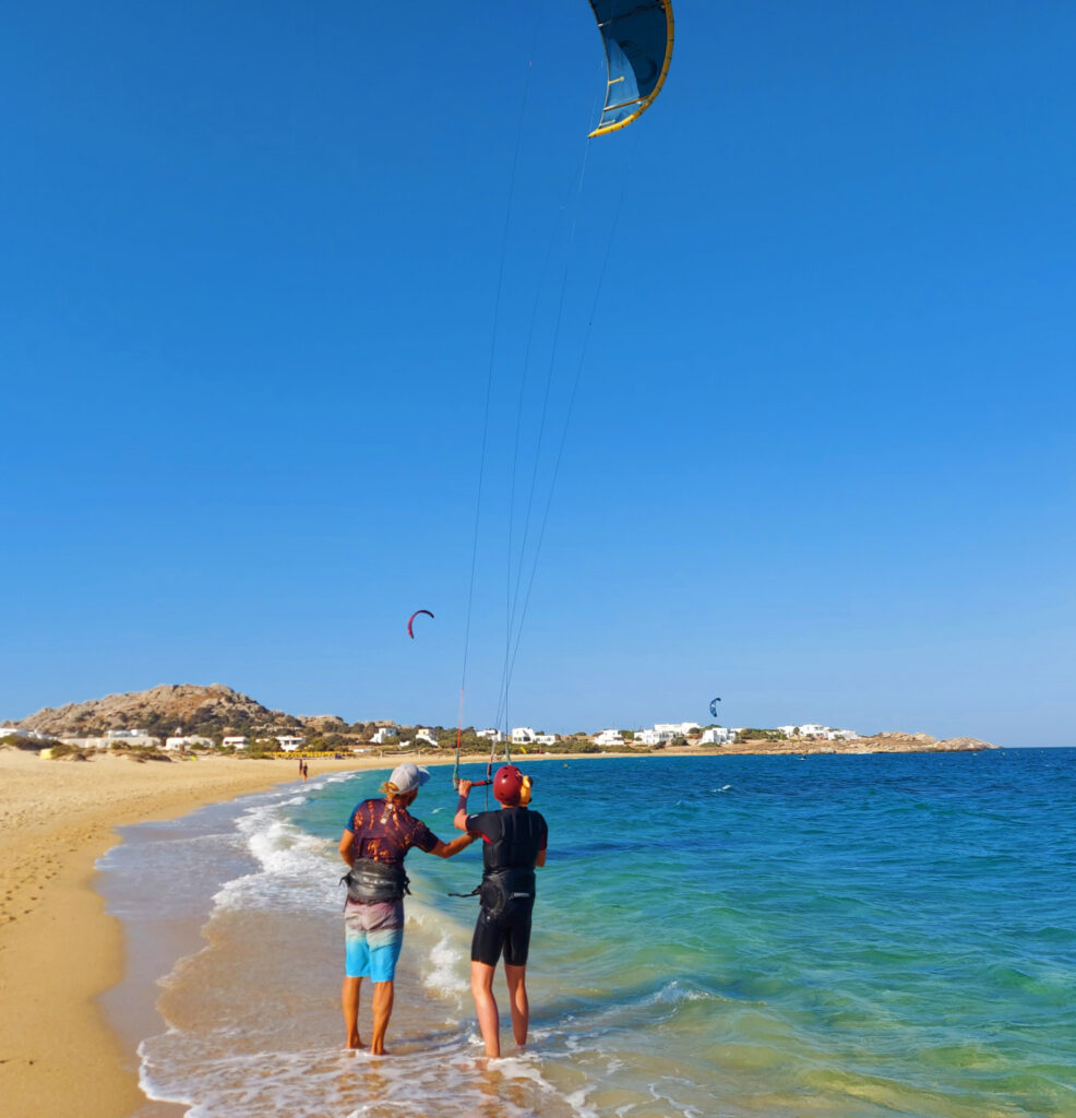 One students  is practising kite control at the beach