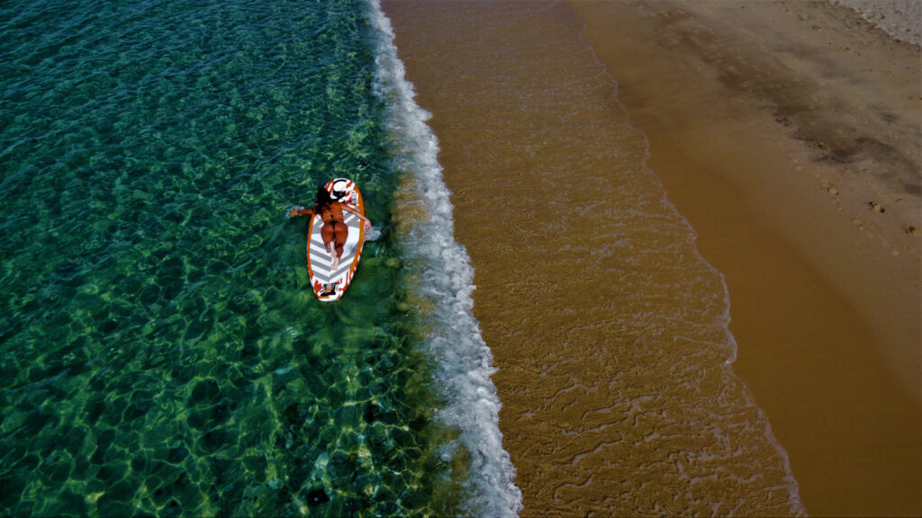 Enjoying a no windy day at Plaka beach by doing Sup.