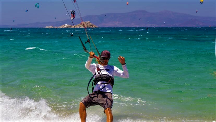 kitesurfing instructor demonstrate to his student 