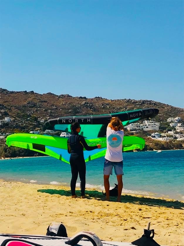 Instructor give a wingfoil lesson at the beach