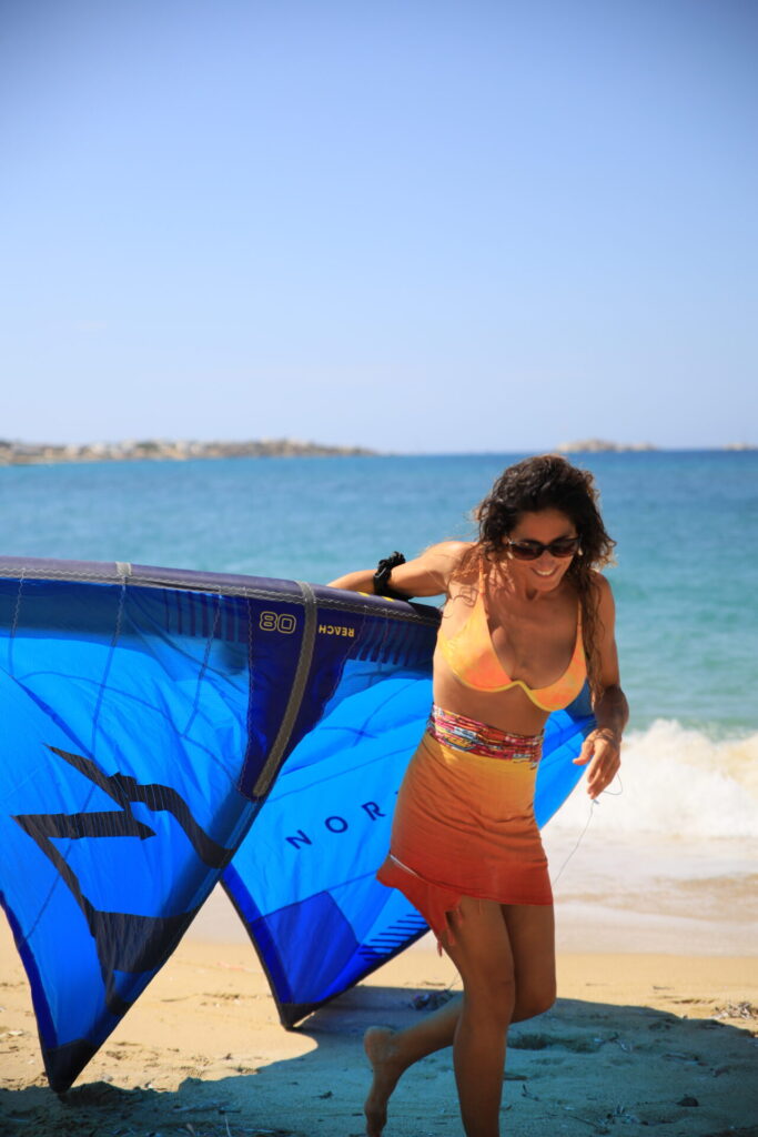 a happy kitesurfing girl at plaka beach